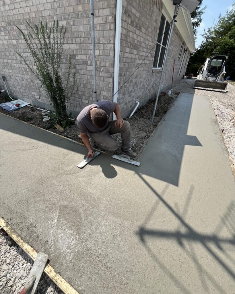 Concrete worker hand-troweling a fresh commercial slab in Fayetteville, NC