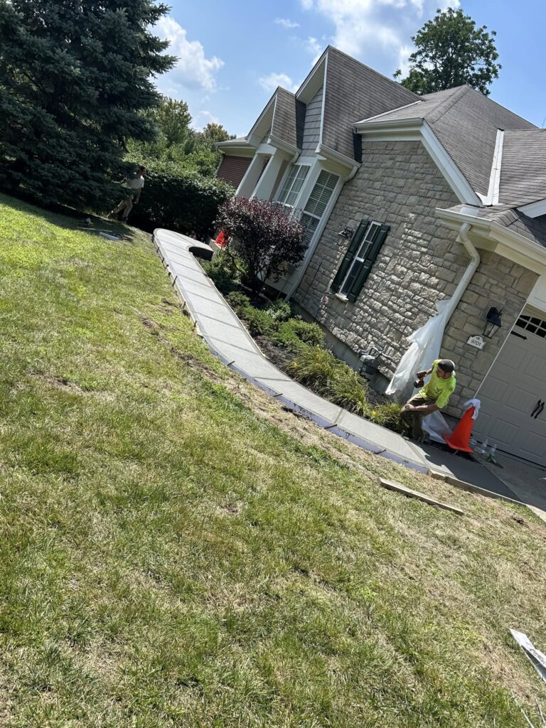 Concrete driveway and steps installed on a sloped residential lot in Fayetteville, NC